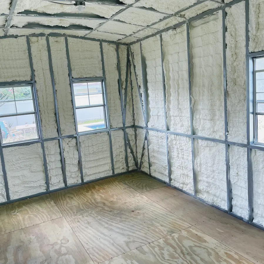Closed-cell spray foam insulation applied to wall cavities in a residential project in Menominee